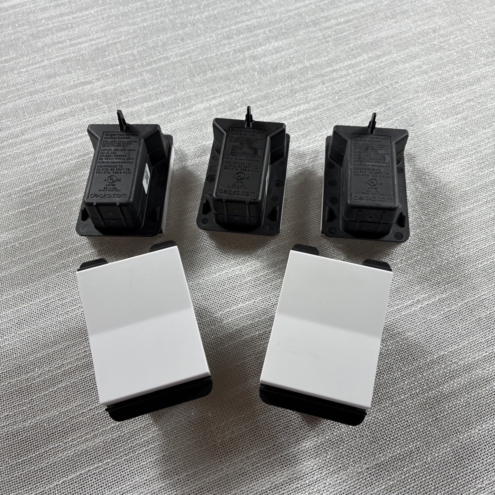 Deako Simple Snap Light 5 Switches in white. These are standard on/off switches