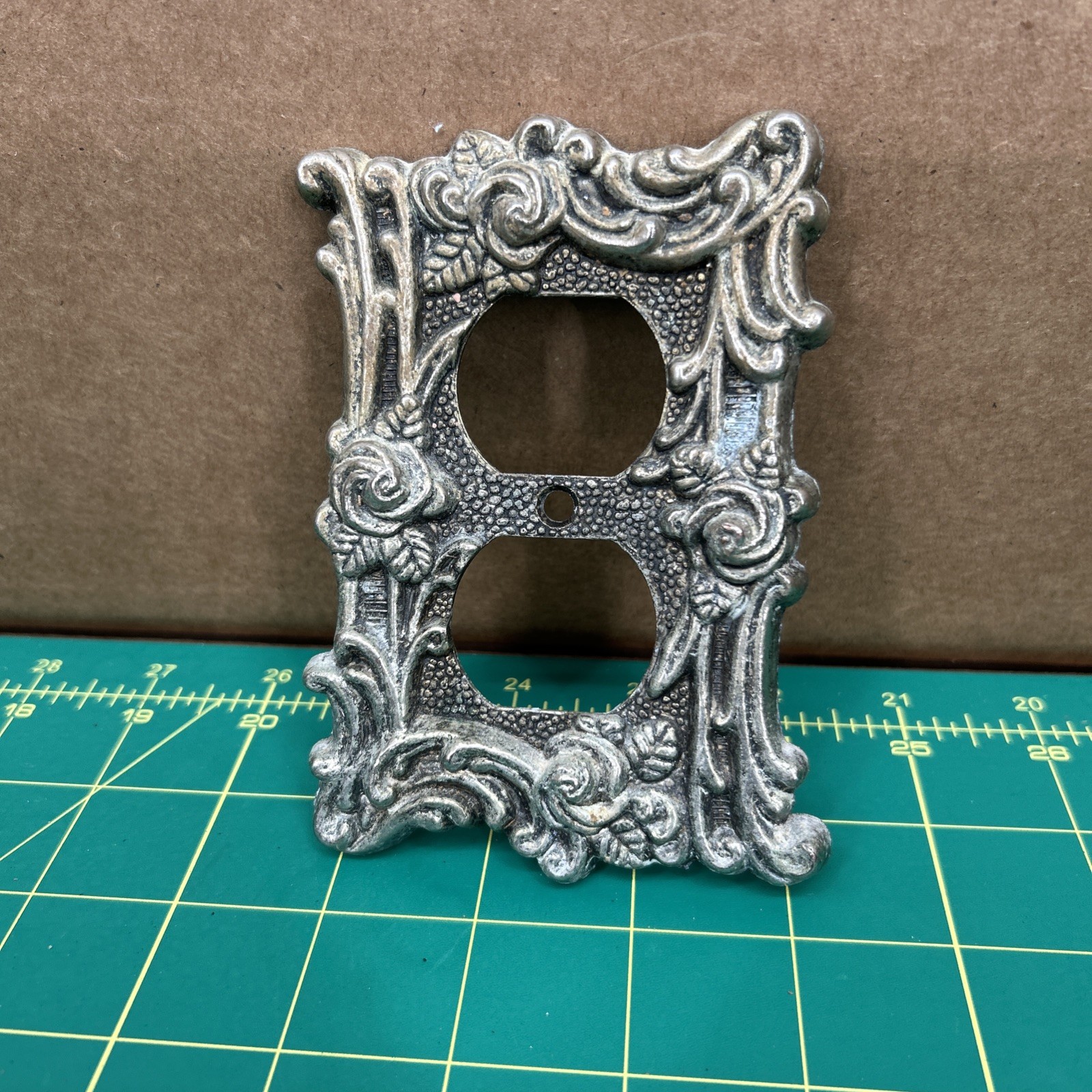 American Tack & Hardware Outlet Plate Provincial 60D Floral Has Corrosion