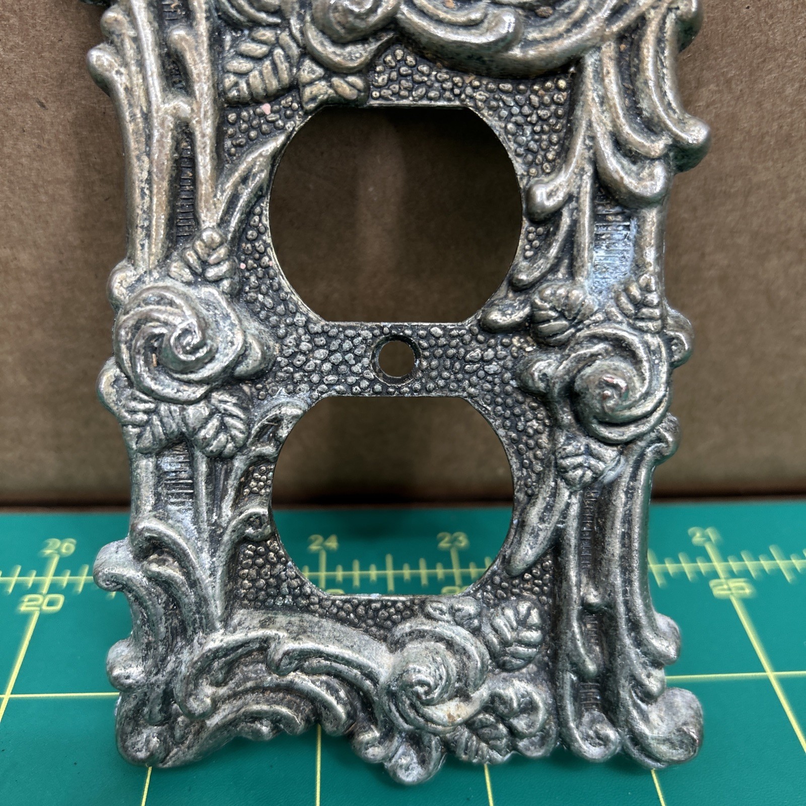 American Tack & Hardware Outlet Plate Provincial 60D Floral Has Corrosion